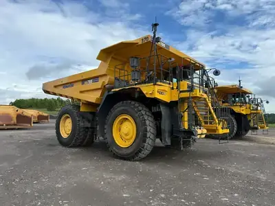 Yellow front loader moving rocks at a quarry.