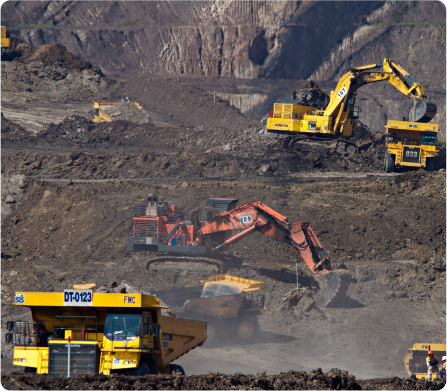 Yellow front loader moving rocks at a quarry.
